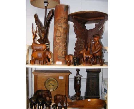 Two shelves of treen and other wooden collectables, including an oak cased mantel clock 