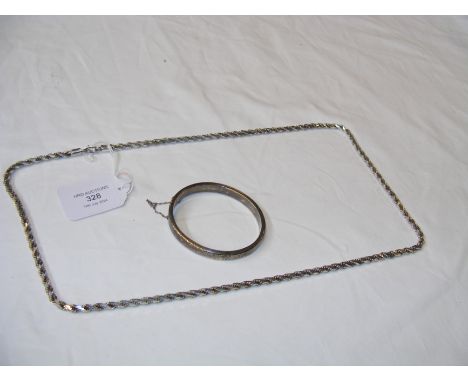 A silver necklace together with bangle