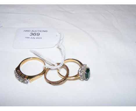 A gold dress ring and two others