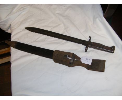 A WWII saw back sword bayonet with scabbard - 51cm long overall