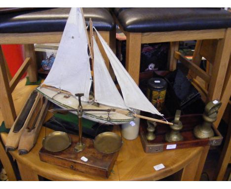 A model sailing boat, together with vintage scales, trays and other assorted collectables 