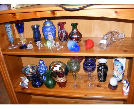 Two shelves of collectable ceramic and glass including Swarovski style animal ornaments