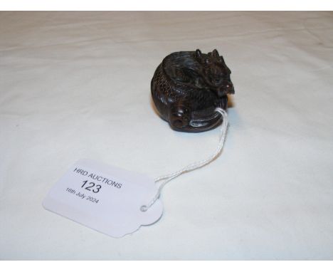 A carved wooden netsuke of mythical beast 