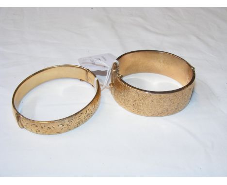 A 9ct gold bangle, together with one other gold plated bangle