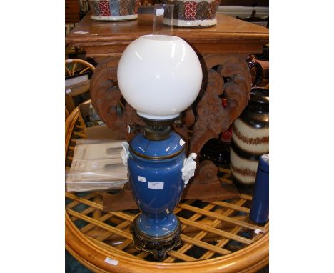 A Victorian oil lamp with milk glass shade 
