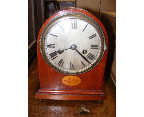 An antique mantel clock with inlaid marquetry shell