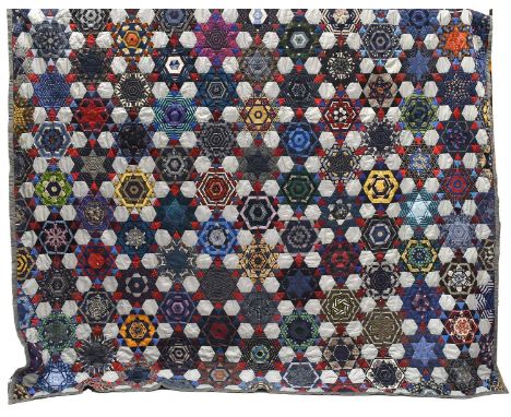 A Modern Patchwork Quilt comprising a stylish design incorporating silk ties in a star pattern overall, with a navy cotton re