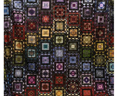 A Modern Patchwork Quilt comprising coloured squares incorporating silk ties, overstitched with gilt thread, with a white cot