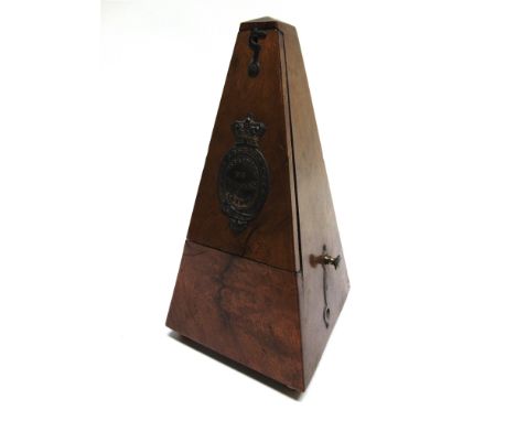 A MAELZEL METRONOME  in a walnut veneered case, 23cm high.