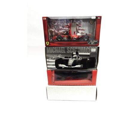 FOUR 1/18 SCALE FERRARI FORMULA 1 RACING CARS  comprising a Hot Wheels Ferrari (M. Schumacher), Seven Times F1 World Champion