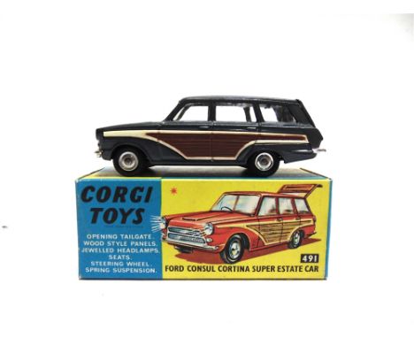 A CORGI NO.491, FORD CONSUL CORTINA SUPER ESTATE CAR  gun metal with faux wood side panels, mint, boxed, the box very good.