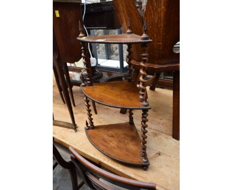 An antique walnut three tier graduated hanging corner shelf, 43cm wide.  