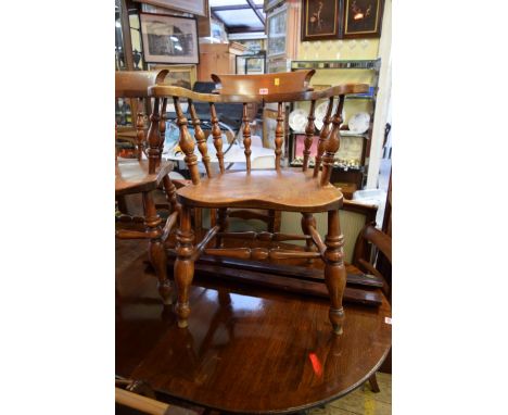 A pair of Victorian beechwood and elm smoker's bow armchairs. 