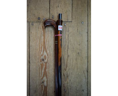 A lignum vitae and bone inlaid walking cane; together with another silver mounted cane, possibly laburnum; and another hardwo