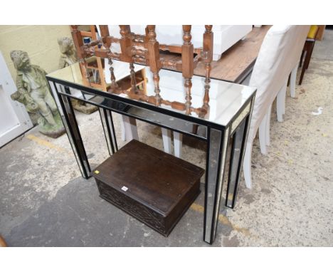 A contemporary mirrored glass console table, 101cm wide.