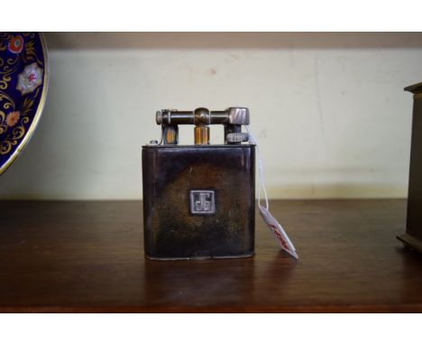 A Dunhill Jumbo lighter, plated with leather cover, 10.5cm.
