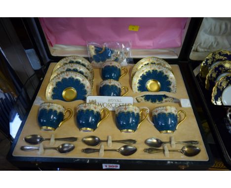 A cased set of six Royal Worcester coffee cups and saucers, circa 1931, with six silver gilt teaspoons, by Henry James Hulber