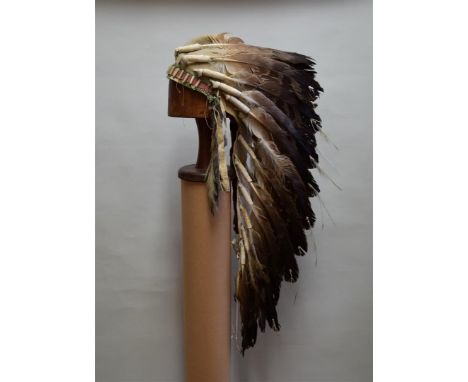 A rare late 19th/early 20th century Native American eagle feather war bonnet, with felt ground and twenty-three attached feat