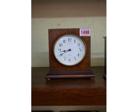 An early 20th century mahogany and brass strung mantel timepiece, the circular enamel dial inscribed 'Jas Shoolbred & Co, Lon
