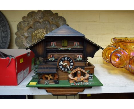 A Swiss carved and painted wood automata and musical cuckoo clock, 29cm wide. 