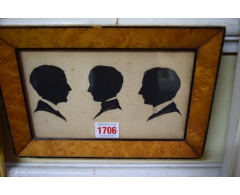 Three 19th century silhouette portrait profiles, framed as one, 11.5 x 19.5cm, in a birdseye maple frame. 