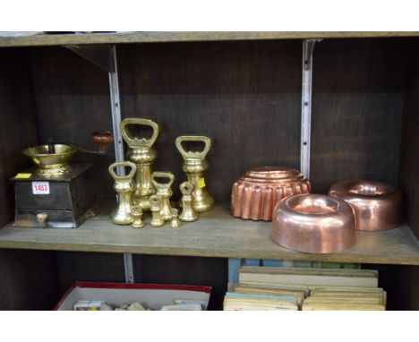 Three Victorian copper jelly moulds; together with a graduated set of eight brass bell weights; and an antique coffee grinder