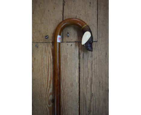 An antique novelty carved wood and ivory hound's head walking stick, the well carved head with trigger opening mouth and glas