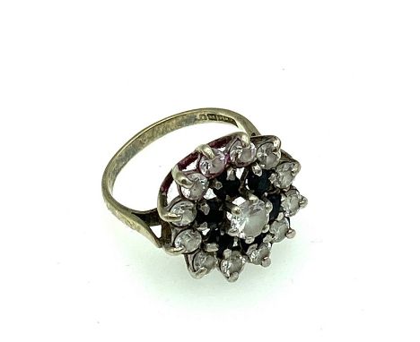 A silver dress ring, with a cluster of garnet and white stones 