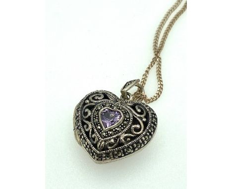 An ornate vintage heart shaped pendant locket necklace 