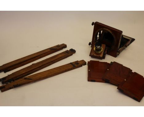 An early 20th century Half Plate 'Triple Victo' mahogany and brass field camera with black leather bellows, tripod, 3 lenses 