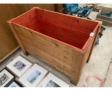 A WOODEN PLANTER TROUGH 