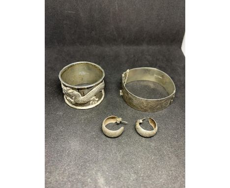 THREE SILVER ITEMS TO INCLUDE A BANGLE, ORIENTAL NAPKIN RING AND A PAIR OF EARRINGS 