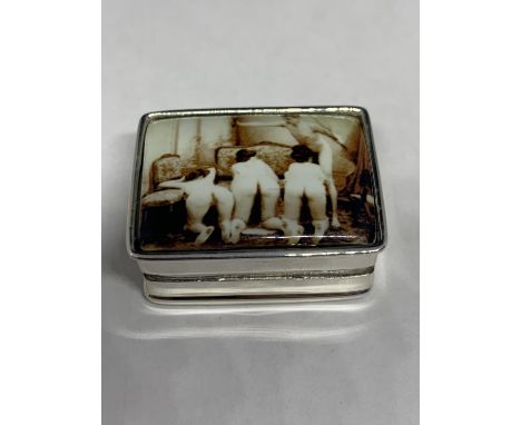 A SILVER PILL BOX WITH AN ENAMEL EROTIC DESIGN ON THE LID 