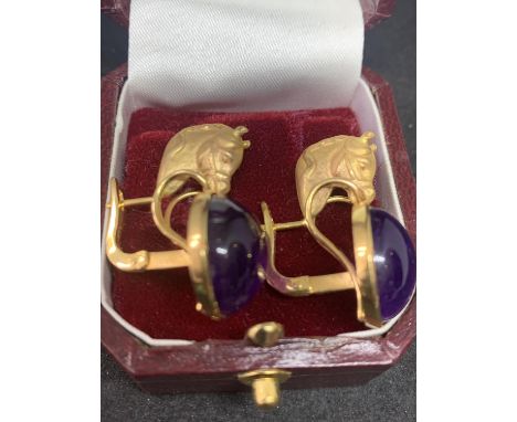 A PAIR OF 12 CARAT YELLOW GOLD HORSES HEAD  DESIGN EARRINGS WITH CABOUCHON AMETHYST  DECORATION BY LUIGI FERRARA NAPLES IN A 