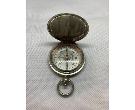 A WHITE METAL MILITARY COMPASS IN THE STYLE OF A POCKET WATCH 