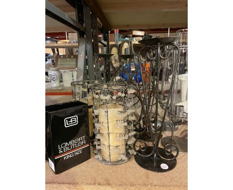 A CAST METAL SIX BOTTLE WINE RACK SIX TALL CANDLESTICKS AND A BLACK CERAMIC JUG 
