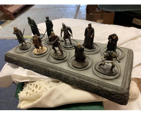 A COLLECTION OF TEN LORD OF THE RINGS FIGURES ON DISPLAY STAND 