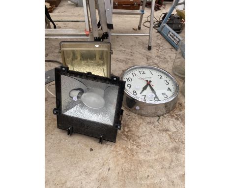 A WALL CLOCK AND TWO OUTDOOR SPOTLIGHTS 