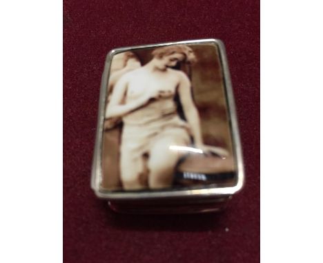 A SILVER PILL BOX WITH AN ENAMEL EROTIC DESIGN ON THE LID 