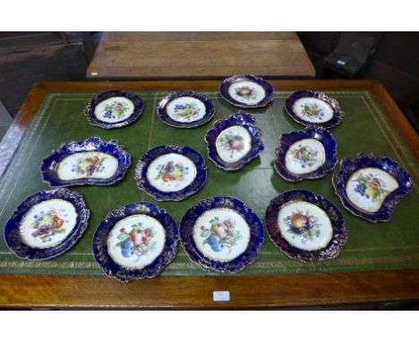 A Hammersley porcelain thirteen piece dessert service, decorated with transfer printed fruit and flowers within a cobalt blue