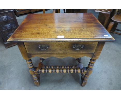 An 18th Century style oak single drawer bobbin turned side table 