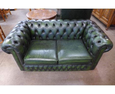 A green leather Chesterfield settee 