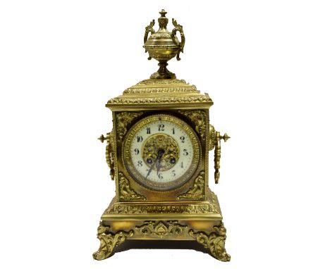 Victorian brass mantel clock crested with an urn over an Arabic chapter ring, 21cm wide