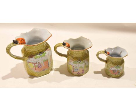 Graduated set of early 19th century Mason's Ironstone jugs with biting snake handles, the yellow scale ground decorated with 