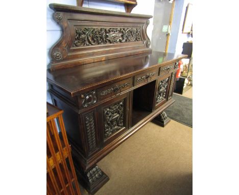 Italian dark oak sideboard pediment moulded with foliage and scrolls over three drawers and central shelf flanked on either s