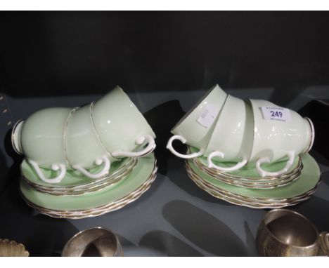 A selection of vintage tea cups and saucers with two tone green and white