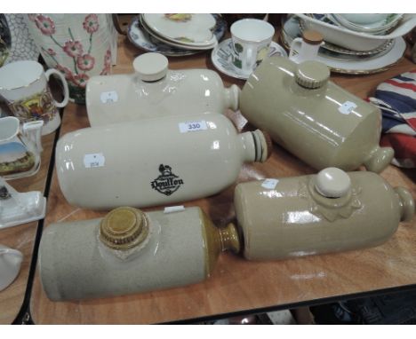 A collection of five ceramic bed warmers