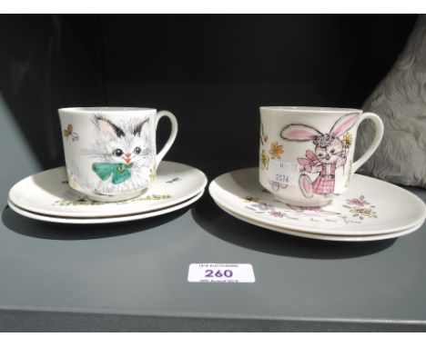 Two vintage cup and saucer sets hand detailed with rabbit and cat designs