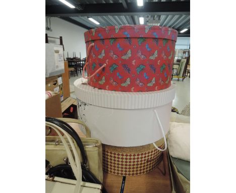Three decorative hat boxes containing a selection of lady's hats including vintage