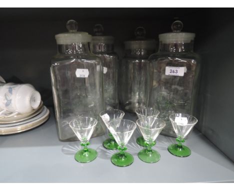 A selection of vintage kitchen jars and similar green stem cocktail glasses